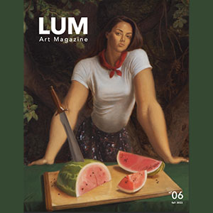Cover of Lum Art Magazine - female figure in forest setting, leaning forward and staring directly at viewer. She has both arms spread out on a table on which sit a sliced watermelon and knife on a cutting board.